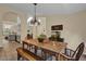 Dining room showcases an arched entry, chandelier, tile flooring, and a view of the kitchen at 322 Harbor Trl, Enterprise, FL 32725