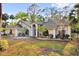 Charming single-story home boasting mature landscaping, a gray roof, and a welcoming front entrance at 322 Harbor Trl, Enterprise, FL 32725
