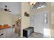 Bright foyer featuring tile floors, a high ceiling, and a decorative transom window above the front door at 322 Harbor Trl, Enterprise, FL 32725
