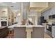 Open kitchen design features modern gray cabinets, stainless steel appliances, and a large island with seating at 322 Harbor Trl, Enterprise, FL 32725