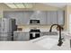 This kitchen features sleek gray cabinets, stainless steel appliances, and a modern countertop at 322 Harbor Trl, Enterprise, FL 32725