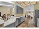 Well-equipped kitchen featuring gray cabinets, quartz countertops, stainless steel appliances, and an open layout at 322 Harbor Trl, Enterprise, FL 32725