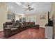 Spacious living room with hardwood floors, a ceiling fan, and French doors leading to the backyard at 322 Harbor Trl, Enterprise, FL 32725
