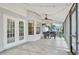 Charming screened patio features tiled floor, ceiling fan and backyard views, ideal for outdoor living at 322 Harbor Trl, Enterprise, FL 32725