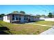 Expansive backyard with a patio area perfect for outdoor dining and relaxation, ideal for enjoying sunny days at 345 W Seminole Ave, Eustis, FL 32726