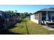 Spacious backyard with lush grass, patio seating, and a secure fence, offering a private outdoor living area at 345 W Seminole Ave, Eustis, FL 32726