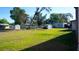 Large backyard with mature trees and ample space for various activities, enhanced by a secure fenced perimeter at 345 W Seminole Ave, Eustis, FL 32726