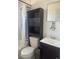 Compact bathroom features a combination of shower, toilet, and storage solutions for convenience at 345 W Seminole Ave, Eustis, FL 32726