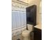 Compact bathroom features a combination of shower, toilet, and storage solutions for convenience at 345 W Seminole Ave, Eustis, FL 32726