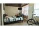 Modest bedroom with a bed, television, and natural light from the window, creating a simple, functional space at 345 W Seminole Ave, Eustis, FL 32726