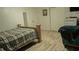 Bedroom features wood-look flooring, bed, and chair at 345 W Seminole Ave, Eustis, FL 32726