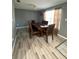 Comfortable dining space featuring wood floors, gray walls, chandelier and an attractive table set at 345 W Seminole Ave, Eustis, FL 32726
