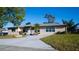 Charming home with a well-maintained lawn, inviting driveway, and beautiful landscaping at 345 W Seminole Ave, Eustis, FL 32726
