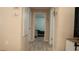 Hallway with hardwood-style flooring and neutral colors provides seamless transition between rooms at 345 W Seminole Ave, Eustis, FL 32726