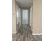 Hallway with hardwood-style flooring and neutral colors provides seamless transition between rooms at 345 W Seminole Ave, Eustis, FL 32726
