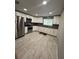 Beautiful kitchen featuring stainless steel appliances, white cabinets, and sleek countertops at 345 W Seminole Ave, Eustis, FL 32726
