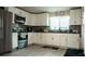 Bright kitchen features white cabinets, tiled backsplash, and modern appliances for a stylish space at 345 W Seminole Ave, Eustis, FL 32726