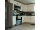 Bright kitchen features white cabinets, tiled backsplash, and modern appliances for a stylish space at 345 W Seminole Ave, Eustis, FL 32726