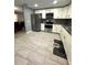Modern kitchen with stainless appliances, bright white cabinetry, and tiled flooring at 345 W Seminole Ave, Eustis, FL 32726