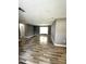 Spacious living room with modern floors and freshly painted gray walls and a window to let light in at 345 W Seminole Ave, Eustis, FL 32726