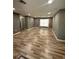 Bright living room with new wood flooring, freshly painted gray walls and natural light at 345 W Seminole Ave, Eustis, FL 32726