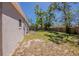 Large backyard features lush green lawn and a wood privacy fence at 3706 Wade Rd, Orlando, FL 32808