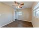 Bright bedroom features a ceiling fan, closet, window, and modern dark wood flooring at 3706 Wade Rd, Orlando, FL 32808
