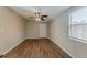 Bedroom with wood-look floors, window, and door at 3706 Wade Rd, Orlando, FL 32808