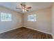 Bedroom features updated floors, ceiling fan, and two windows at 3706 Wade Rd, Orlando, FL 32808