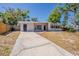 Beautiful single-story home showcasing a long driveway and well-manicured front lawn at 3706 Wade Rd, Orlando, FL 32808
