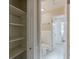 Hallway view with storage shelves leading to the bathroom at 3706 Wade Rd, Orlando, FL 32808