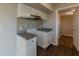 Modern kitchen featuring sleek white cabinets, beautiful backsplash, and stainless steel appliances at 3706 Wade Rd, Orlando, FL 32808