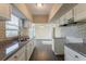 Updated kitchen features granite countertops and stylish backsplash and stainless vent hood at 3706 Wade Rd, Orlando, FL 32808