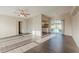 Living room view with ceiling fan, access to the yard, and adjacent kitchen at 3706 Wade Rd, Orlando, FL 32808