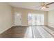 Bright living room boasts a ceiling fan and sliding glass door with sunlit ambiance at 3706 Wade Rd, Orlando, FL 32808