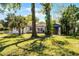 Exterior view showing the well-maintained lawn, additional covered seating, and home features at 407 E Jersey St, Orlando, FL 32806
