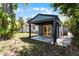 Charming backyard retreat featuring a cozy patio and well-maintained landscaping at 407 E Jersey St, Orlando, FL 32806