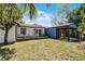 A backyard with outdoor seating, a grill, and an exterior view of the home at 407 E Jersey St, Orlando, FL 32806