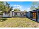 A backyard with outdoor seating, a grill, and an exterior view of the home at 407 E Jersey St, Orlando, FL 32806