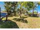 A large backyard with trees and greenery offering plenty of space and privacy at 407 E Jersey St, Orlando, FL 32806
