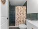 Bathroom featuring a shower with dark tile and stylish white fixtures at 407 E Jersey St, Orlando, FL 32806
