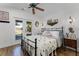 Bright bedroom with a decorative quilt, ceiling fan, and backyard access at 407 E Jersey St, Orlando, FL 32806