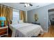 Bright bedroom with hardwood floors, neutral colors, and two windows with gold drapes at 407 E Jersey St, Orlando, FL 32806