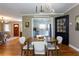 Comfortable dining room, hardwood floors, a modern chandelier, and an open concept to the kitchen at 407 E Jersey St, Orlando, FL 32806