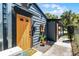 Exterior view showcasing a colorful door, landscaping, and home design elements at 407 E Jersey St, Orlando, FL 32806