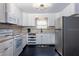 Functional kitchen with white cabinets, stainless steel appliances, and a practical layout at 407 E Jersey St, Orlando, FL 32806