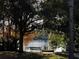 Relaxing view of a calm lake with a bench under the shade of mature trees, perfect for enjoying nature at 407 E Jersey St, Orlando, FL 32806