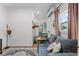 Cozy living room featuring a blue couch, wood floors, and an open view into the kitchen area at 407 E Jersey St, Orlando, FL 32806