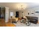 Bright living room featuring hardwood floors, a modern light fixture, and stylish decor at 407 E Jersey St, Orlando, FL 32806