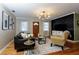 Living room showcasing modern lighting, dark accents, and wood floors at 407 E Jersey St, Orlando, FL 32806